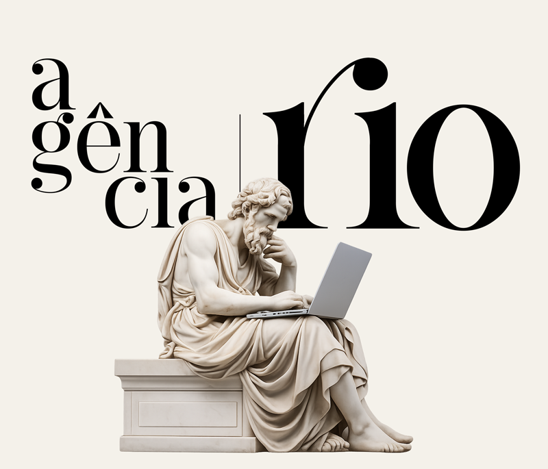 Filósofo de mármore usando um laptop, com a tipografia Agência Rio ao fundo.